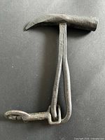 Overall side view of hammer showing head, split handle and hook