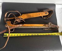 full view of both skates with measuring tape showing length