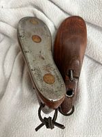 Sole view showing metal plates and leather cord connection