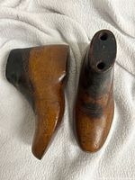 Top and side view of both wooden lasts showing black heel paint and mounting holes