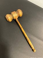 Full view of wooden gavel on black background