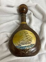 Front view showing sailing ship motif and overall shape