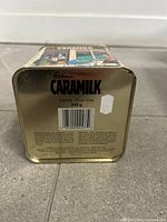 Base of tin showing capacity 240 g, barcode, gold colour, dent on corner