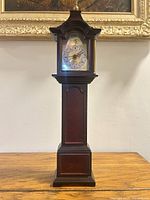 full view of tall wood mantel desk clock on table