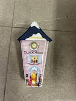 Front view showing house design, clock, doorway