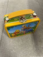 Front angle showing clasp, handle and character graphic