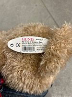 Close-up of sewn label showing GUND logo and #40207 model number