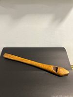 Full view of wooden tool on black background