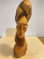 Front view of carved olive wood female bust