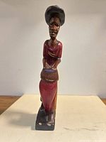 Front view of full 9-inch wooden drummer figurine showing colors and posture