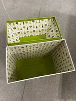 Tin open showing patterned interior of both main compartment and lid tray