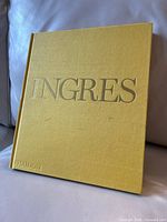 Front cover of yellow hardcover book with embossed title Ingres