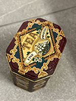 Top view showing TEA graphic and ornate design on lid