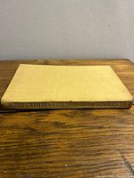 Spine and cover of beige cloth hardcover