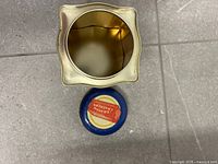 Top view of empty tin showing interior and detached lid