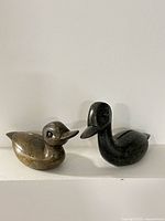 Both soapstone duck sculptures side by side