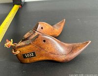 Side view of both wooden shoe lasts showing size and label 1032