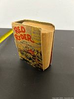 Angled view of book showing spine thickness and front cover art