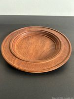 Top view of wooden charger plate showing size, color and turned design