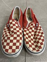 Top view of both sneakers showing checkerboard pattern and overall wear