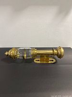 Full view of brass wall sconce assembled