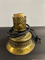 Full view of brass lamp base with cord