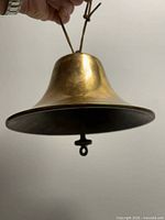 Side view showing full bell profile, flared rim, clapper