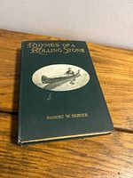 Front cover showing title, author, green cloth boards, pictorial onlay