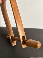 Overall view of wooden clamp showing U frame and sliding peg