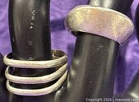 Close-up of both sterling rings on display fingers