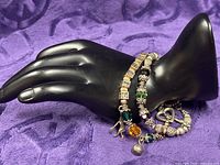 Two sterling bracelets displayed on mannequin hand