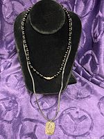 Both necklaces displayed on bust