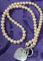 Full view of pearl necklace laid in oval shape