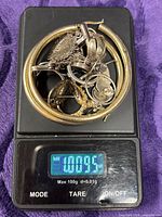 Assorted sterling pieces on digital scale reading 1.09 ozt