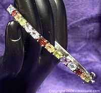 Side view of sterling silver bangle showing mixed gemstones