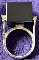 Ring top view showing black square stone and silver band