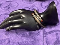 Full view of sterling silver hinged bangle on display hand