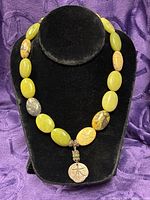 Full view of necklace on display form showing overall design and length