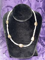 Full view of necklace displayed on black velvet bust