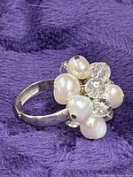 Cluster ring on fabric showing pearls and crystals detail