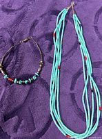 Necklace and bracelet laid flat showing bead design and strand count