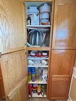 Cabinet overview showing assorted dinnerware, serveware and bakeware