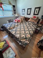 Two single beds side by side showing frames, mattresses, comforters, pillows and shams