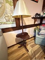 Full view of floor lamp showing shade, pole, side table, legs and cord