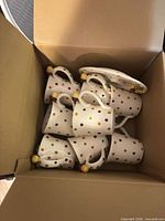 Box containing eight polka dot mugs and one matching plate