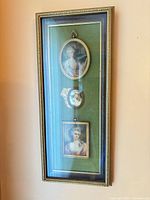 Full view of framed triple miniature portraits hanging on wall