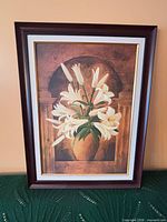 Full view of framed floral print with lilies in vase
