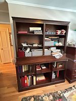 Full front view showing upper shelves, lower cubbies, crown moulding, finish