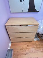 Front view showing three drawers and misalignment