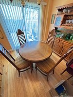 Dining table with four chairs in light oak finish